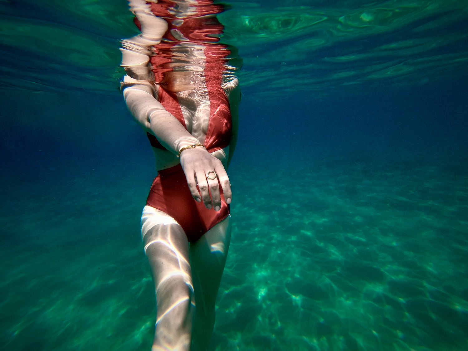 Underwater photo of gold hexagon ring